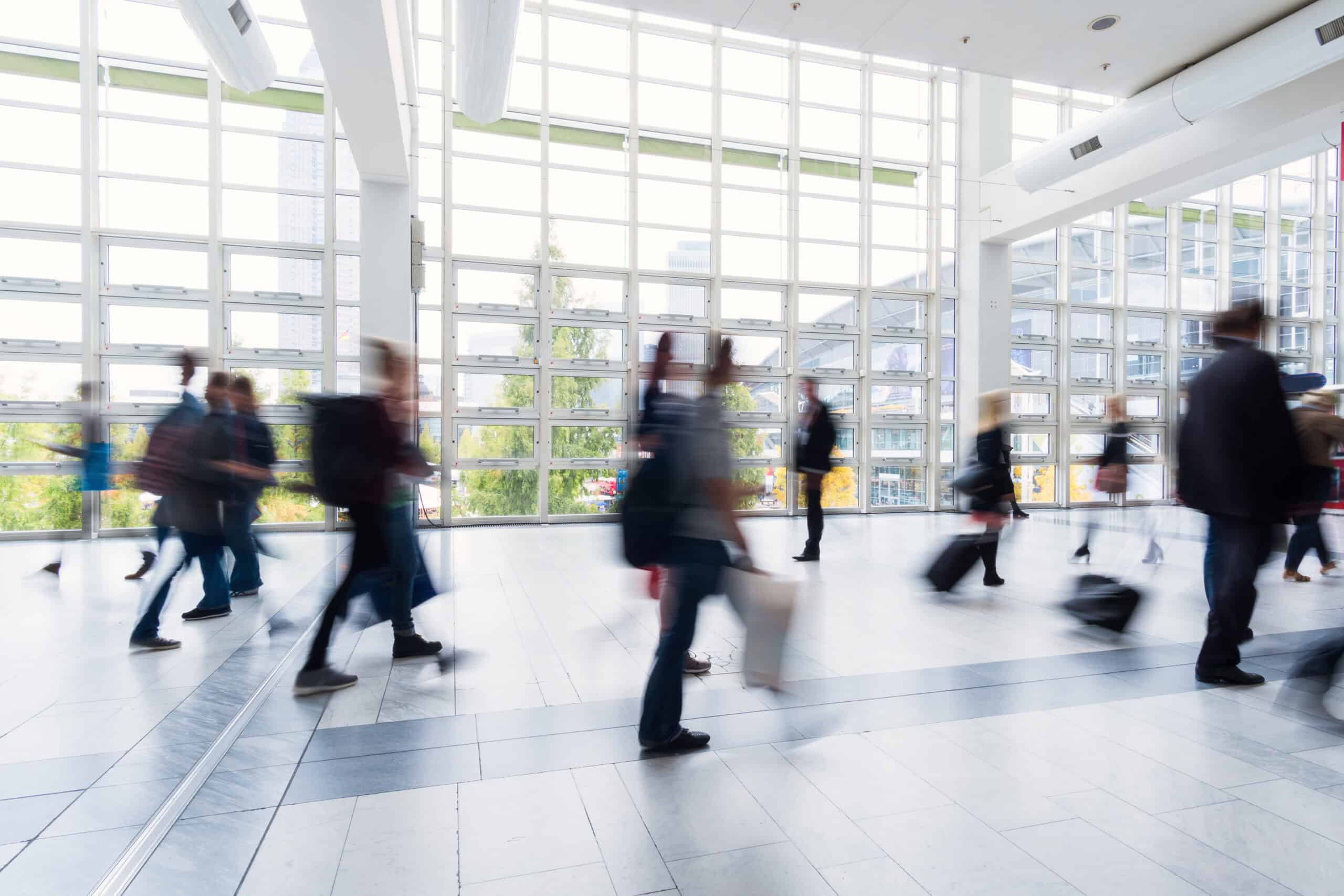 blurred people walking in Frankfurt building